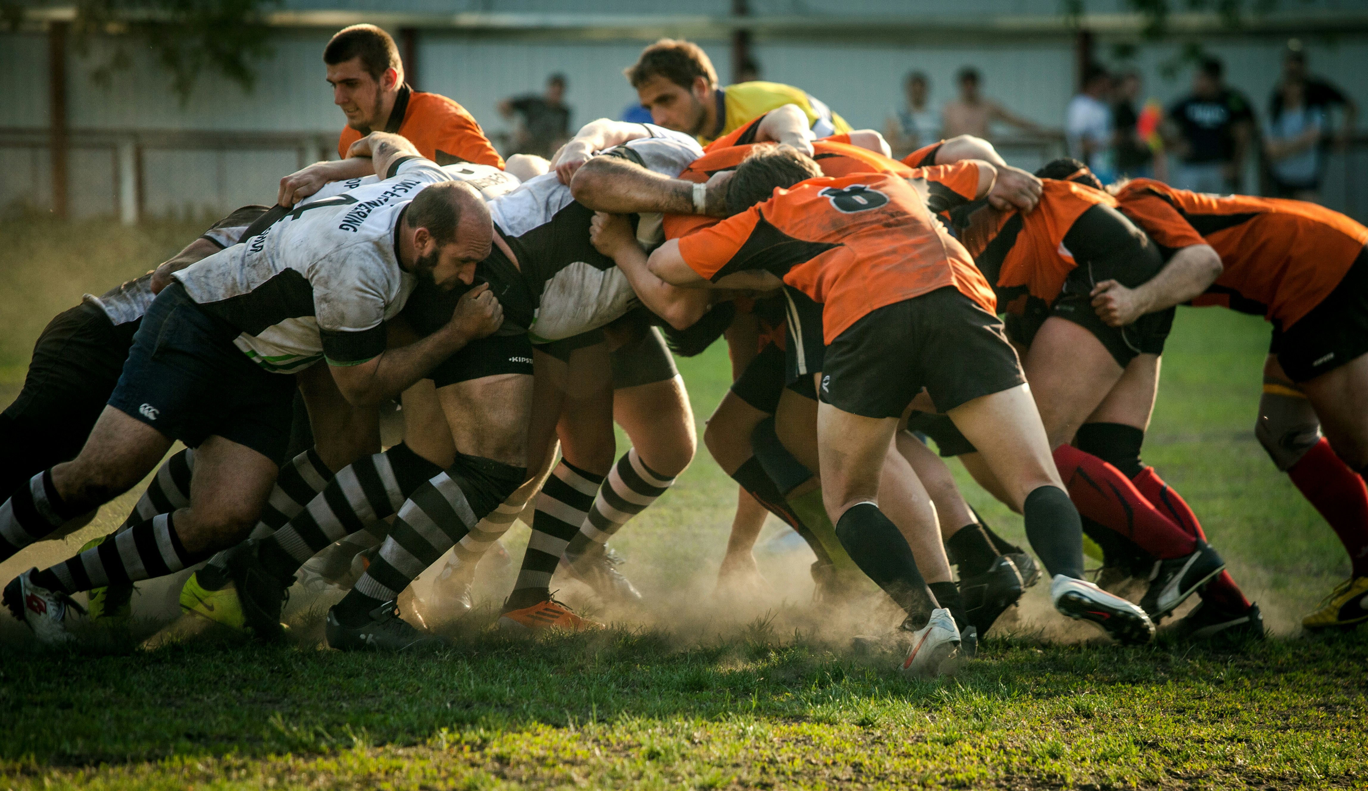 A rugby scrum — two teams locked together, pushing as a unit